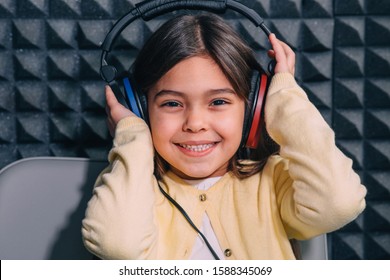 Cute Little Mixed Race Child While Procedure Hearing Exam. Girl Wearing Special Headphones Getting Hearing Test, Audiometry