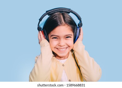 Cute Little Mixed Race Child While Procedure Hearing Exam. Girl Wearing Special Headphones Getting Hearing Test, Audiometry