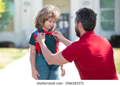 Cute Little Nerd. American Father And Son Walking Trough School Park.