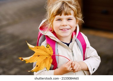 Cute little preschool girl on her first day going to playschool. Healthy happy child walking to nursery school. Kid with backpack going to day care on the city street, outdoors