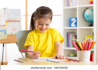 Cute little preschooler child girl drawing at home - Powered by Shutterstock