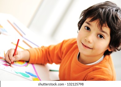 Cute little schoolboy drawing an house and looking at camera - Powered by Shutterstock