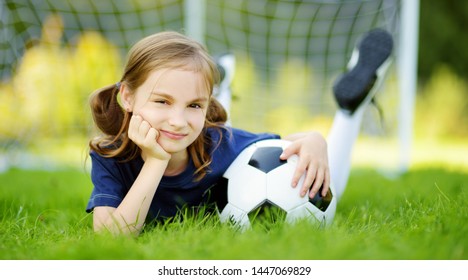 Cute little soccer player having fun playing a soccer game on sunny summer day. Sport activities for children. Kids in sports uniform. - Powered by Shutterstock