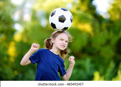 Cute little soccer player having fun playing a soccer game on sunny summer day - Powered by Shutterstock