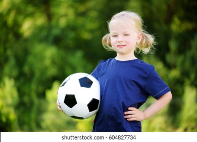 Cute little soccer player having fun playing a soccer game on sunny summer day   - Powered by Shutterstock