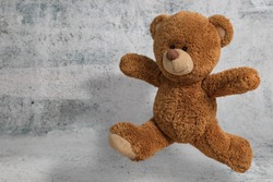 Cute Little Teddy Bear Have Fun Jumping On White Background With Copy Space