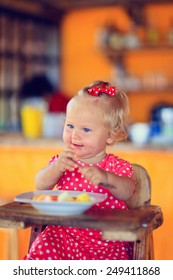 Cute Little Toddler Girl Eating Breakfast In Cafe