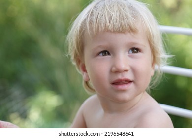 Cute Little White Baby On A Summer Day Outside.