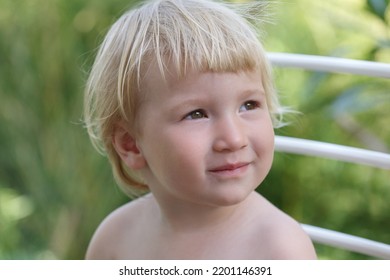 Cute Little White Baby On A Summer Day Outside.