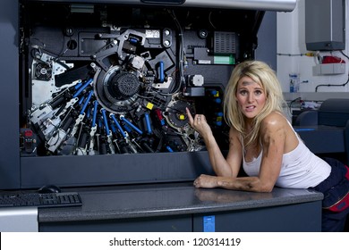 A Cute Looking Blonde Woman Servicing A Digital Printing Press, Gets Covered In Grease And Ink.