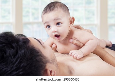 Cute Male Baby In The Bedroom With Dad And Playing Together, Shot At Home