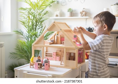 Cute Male Kid Playing Toy Doll House Characters With Interior Furniture Montessori Wooden Eco Friendly Material Early Development Educational Game. Child Boy With Natural Playthings Construction