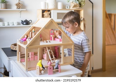 Cute Male Kid Playing Toy Doll House Characters With Interior Furniture Montessori Wooden Eco Friendly Material Early Development Educational Game. Child Boy With Natural Playthings Construction