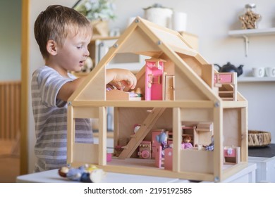 Cute Male Kid Playing Toy Doll House Characters With Interior Furniture Montessori Wooden Eco Friendly Material Early Development Educational Game. Child Boy With Natural Playthings Construction