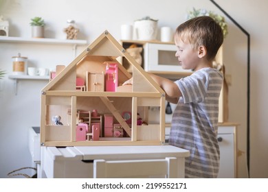 Cute Male Kid Playing Toy Doll House Characters With Interior Furniture Montessori Wooden Eco Friendly Material Early Development Educational Game. Child Boy With Natural Playthings Construction