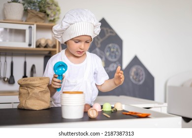 Cute Male Kid Preparing Toy Food Boiling Vegetables On Cooker At Childish Room Kitchen With Montessori Wooden Material. Confident Child Boy Chef Meal Cooking At Cuisine Playing Early Development Game