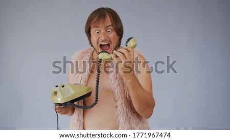 Cute man getting upset while talking on phone, shouting at handset, having unpleasant conversation on telephone support center.