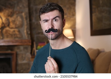 Cute man pretending to have a mustache