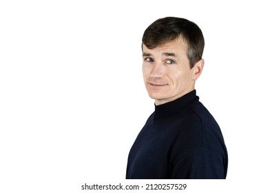 Cute mature slender man smiling on a white background, man's hair begins to turn gray. Portrait of a mature man in a dark golf sweater. Isolated. Copy space