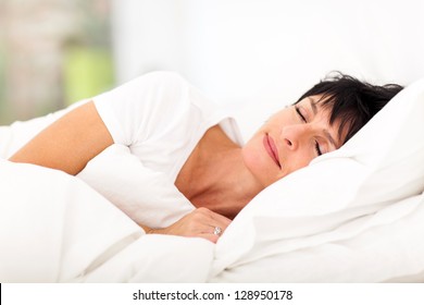 Cute Mature Woman Sleeping On Bed