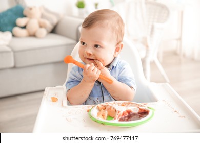 Cute Messy Baby Eating Puree At Home