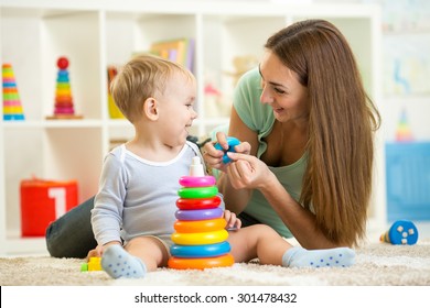 cute mother and child boy play together indoors at home