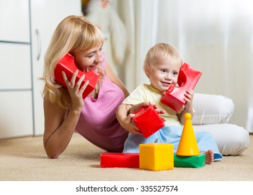 Cute Mother And Kid Boy Role Playing Together Indoor