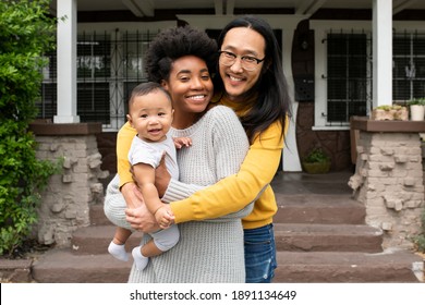 Cute Multiethnic Family Standing At The Porch During Covid19 Lockdown