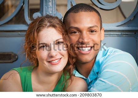 Cute Multiracial couple hugging.