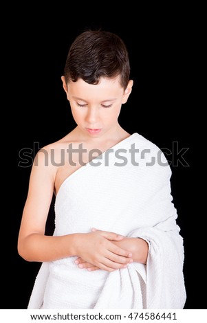 Cute Muslim Kid Praying While Wearing Ihram ( White Traditional Islamic Clothes ) During Hajj