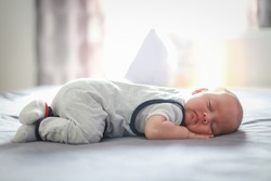 Cute Newborn Baby About Two Months Old Sleep On Stomach On Bed At Home. Mixed Race Asian-German Infant Boy Day Sleeping.