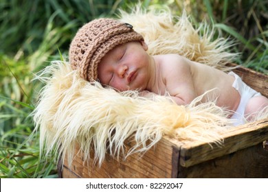 Cute Newborn Baby In A Box, Outdoor Photo