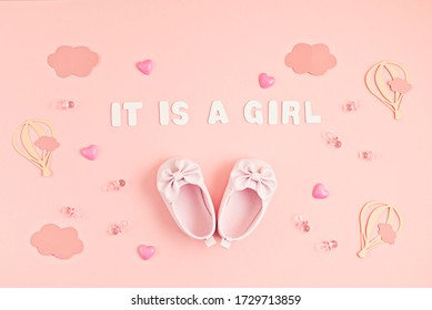 Cute Newborn Baby Girl Shoes With Festive Decoration Over Pink Background. Baby Shower, Birthday, Invitation Or Greeting Card Idea