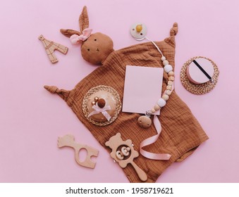 Cute Newborn Baby Items With Decoration Over Brown Background. Baby Shower, Birthday, Invitation Or Greeting Card Idea. Top View Flat Lay 