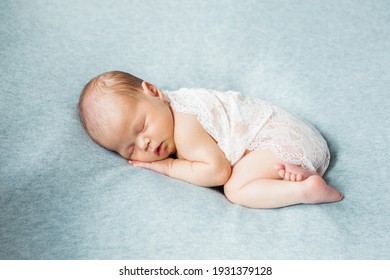 Cute newborn baby on blue background. Copy space and top view