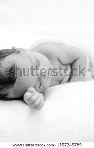 Similar – Image, Stock Photo Newborn baby with pompom hat sleeping and laughing on blanket