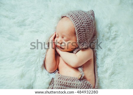 Similar – Newborn baby girl sleeping lying on bed next to mother’s hand