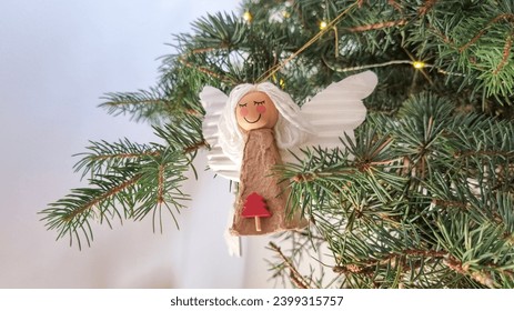 Cute paper angel ornament on the Christmas tree. Handmade decoration. Festive season. - Powered by Shutterstock