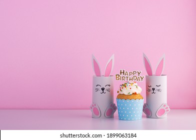 Cute Paper Rabbits From A Roll Of Toilet Paper With The Cake On His Birthday. Background For The Birthday Party. Children's Holiday