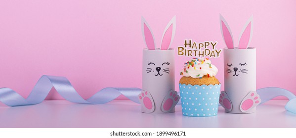 Cute Paper Rabbits From A Roll Of Toilet Paper With The Cake On His Birthday. Background For The Birthday Party. Children's Holiday