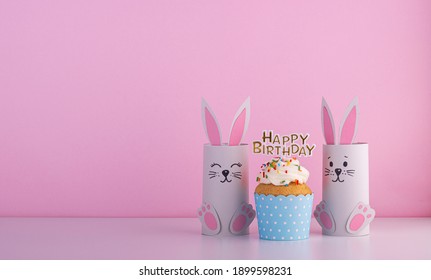 Cute Paper Rabbits From A Roll Of Toilet Paper With The Cake On His Birthday. Background For The Birthday Party. Children's Holiday