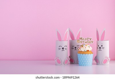 Cute Paper Rabbits From A Roll Of Toilet Paper With The Cake On His Birthday. Background For The Birthday Party. Children's Holiday