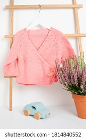 Cute Pink Baby Jacket Hanging On The Rack. Organic Cotton, Handmade Kids Apparel Mockup.