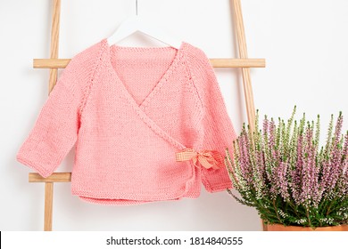 Cute Pink Baby Jacket Hanging On The Rack. Organic Cotton, Handmade Kids Apparel Mockup.