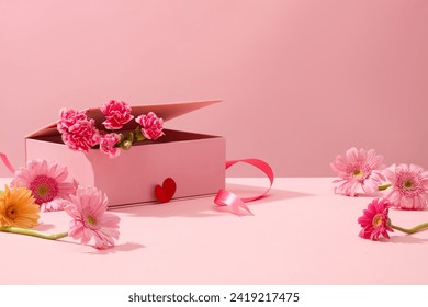 Cute pink background with gerberas and fresh carnations decorated. Sweet and romantic women's day decoration ideas. Empty space for product presentation, front view