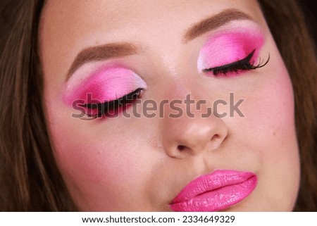 Cute pink eye makeup with matte eyeshadows and girly lashes. Close up realistic photography
