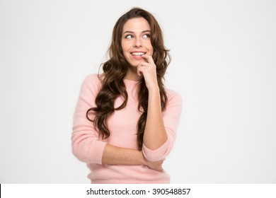 Cute Playful Young Woman Smiling And Thinking Over White Background