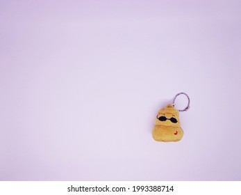 A Cute Poop Key Chain On White Background