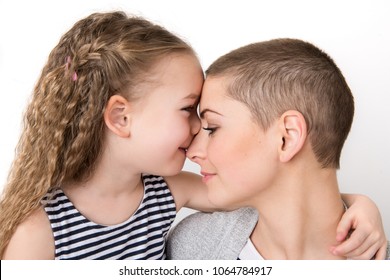Cute preschool age girl with her mother, young cancer patient in remission. Cancer patient and family support concept. - Shutterstock ID 1064784917