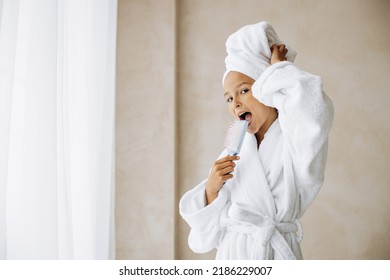 Cute Preteen Girl Singing Using Hair Brush As A Microphone